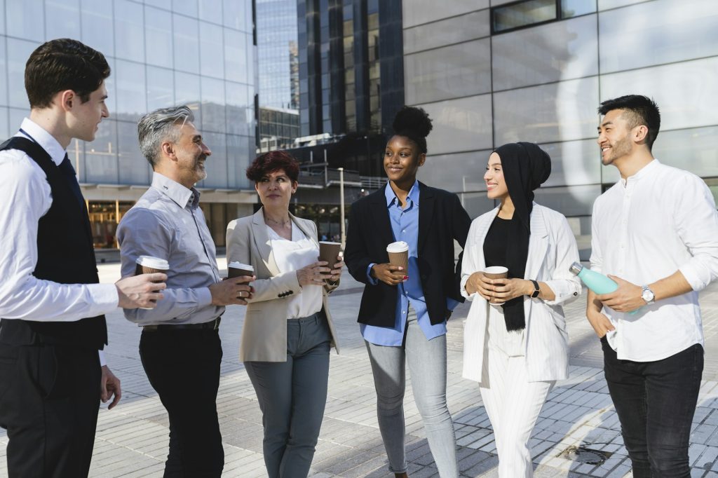 Diverse Business Professionals Networking Outdoors with Coffee